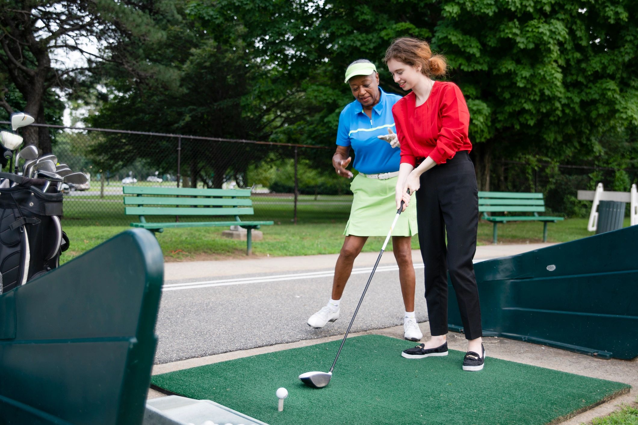 Golf coach teaching a student on the course