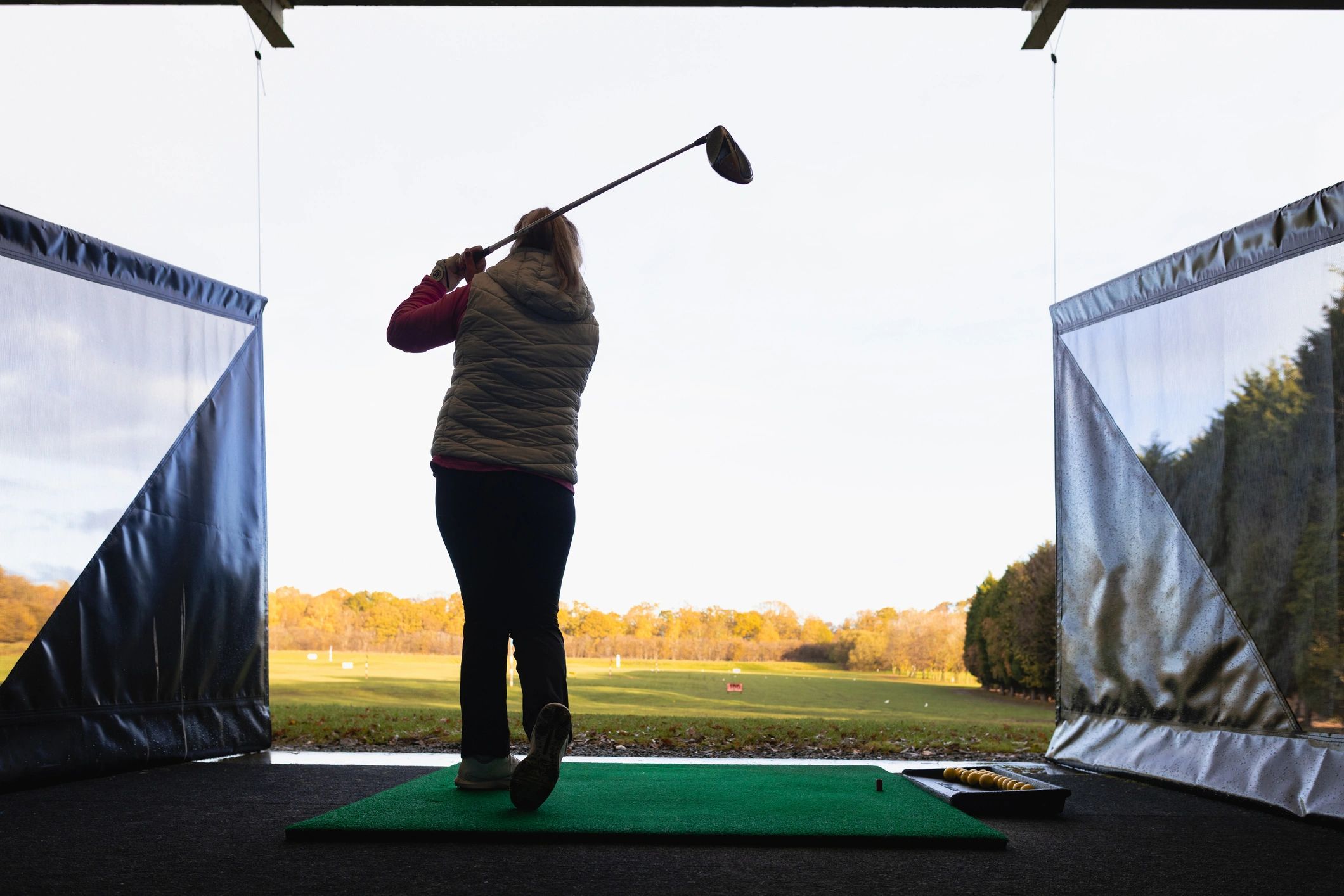 Golfer practicing a swing at the range