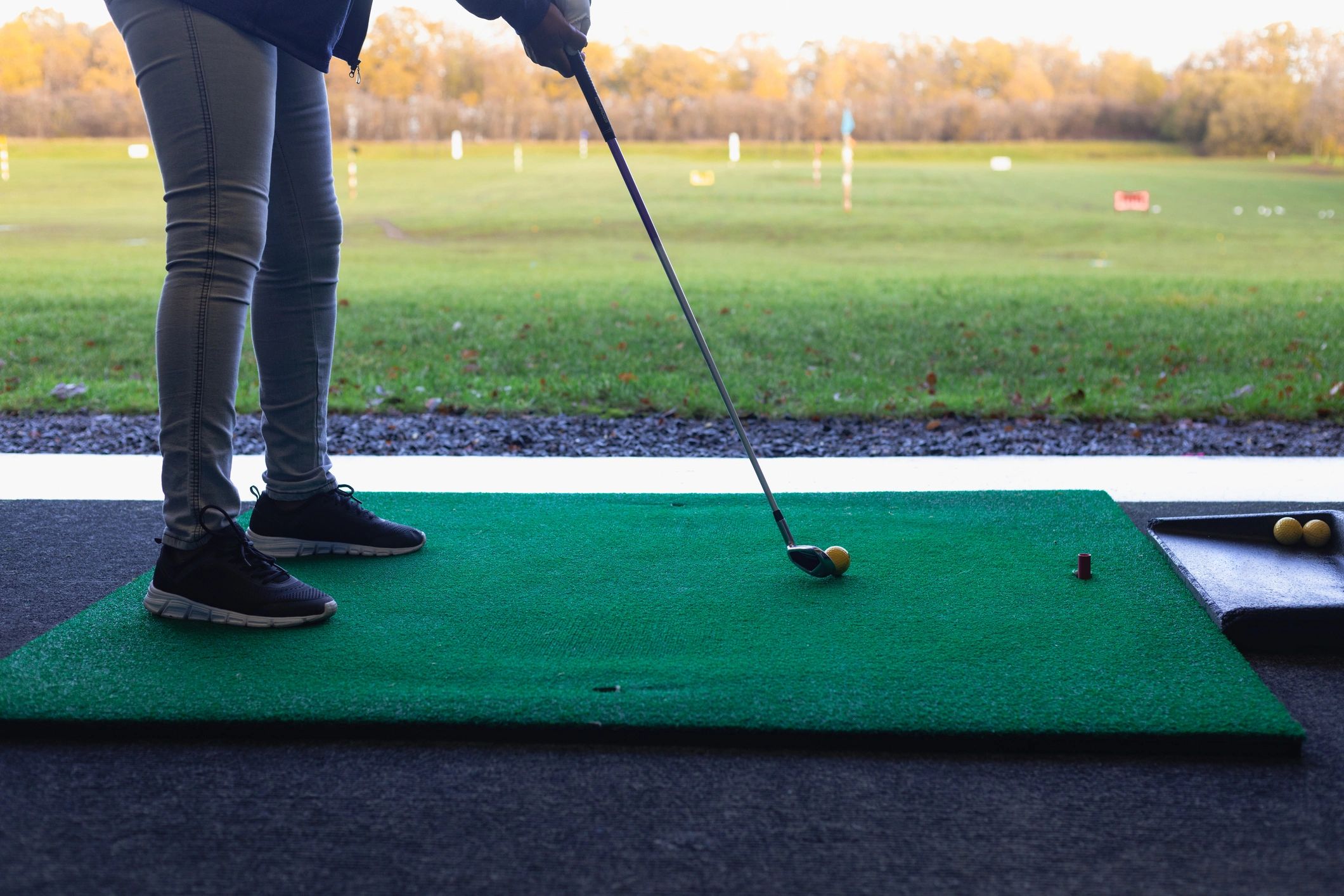 Golfer preparing a shot at the driving range